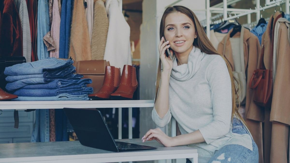 Business owner on the phone while using a laptop